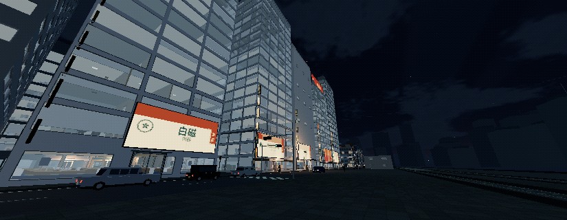 A wide avenue of shopfronts and office towers at night